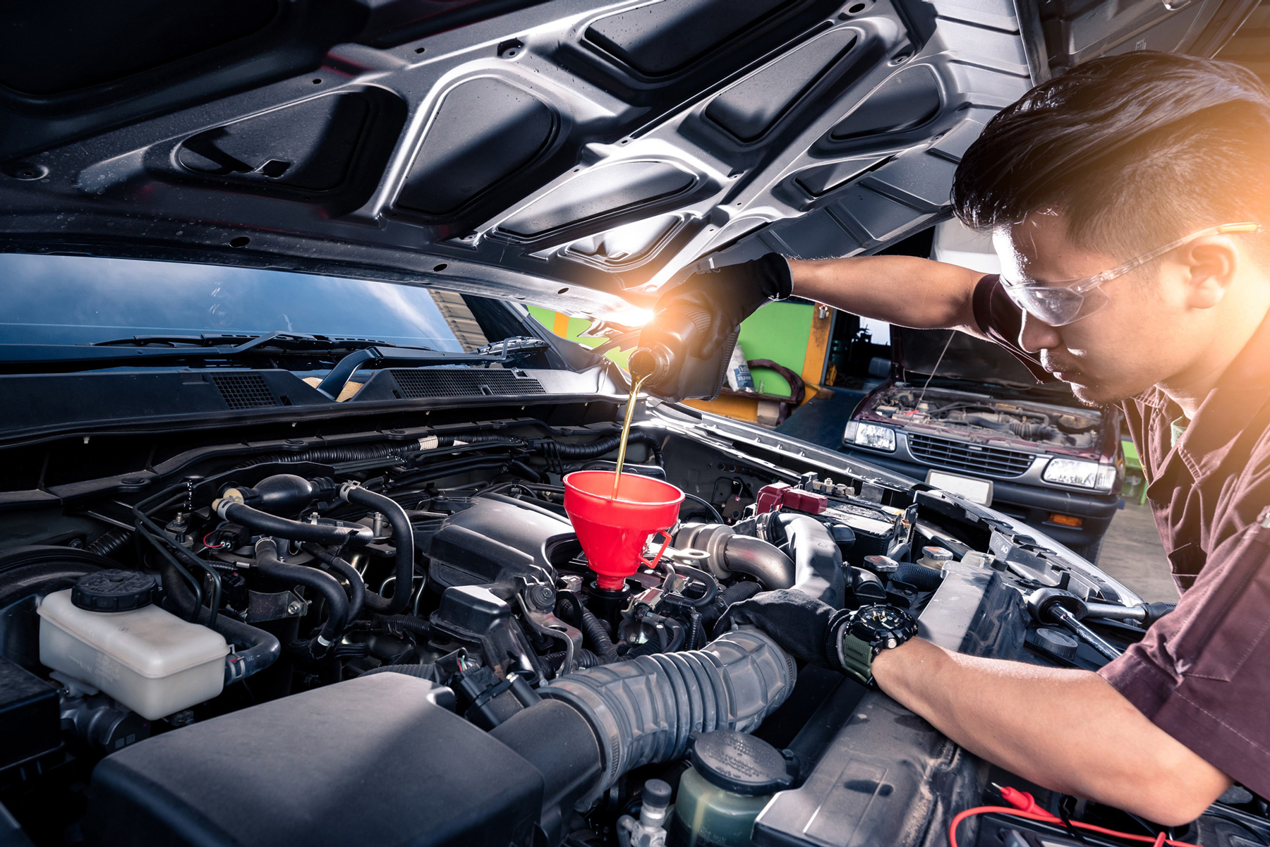 Service technician conducting an oil change
