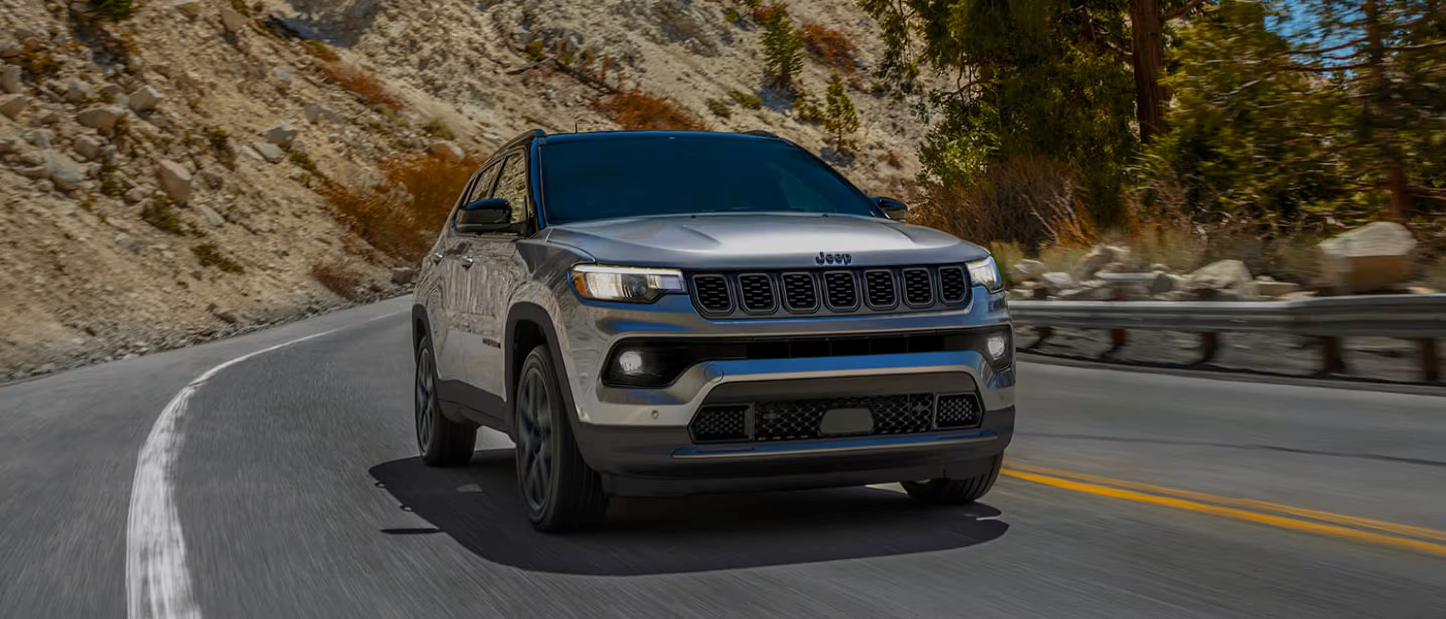 Jeep Compass driving down road.